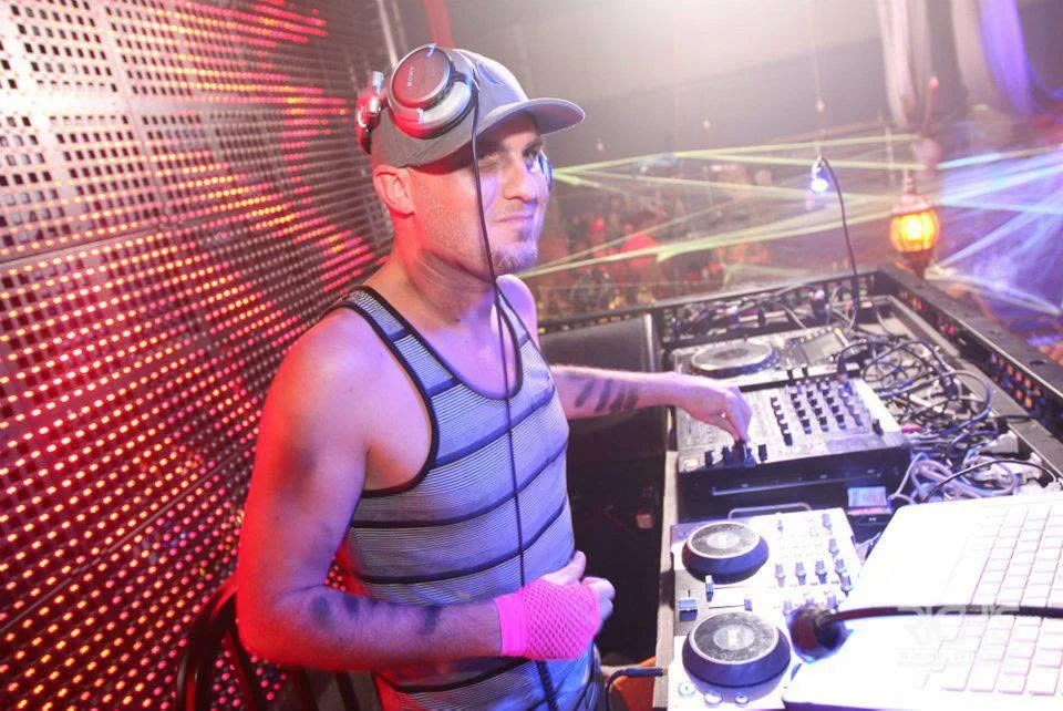 DJ Will Z performing in a nightclub DJ booth