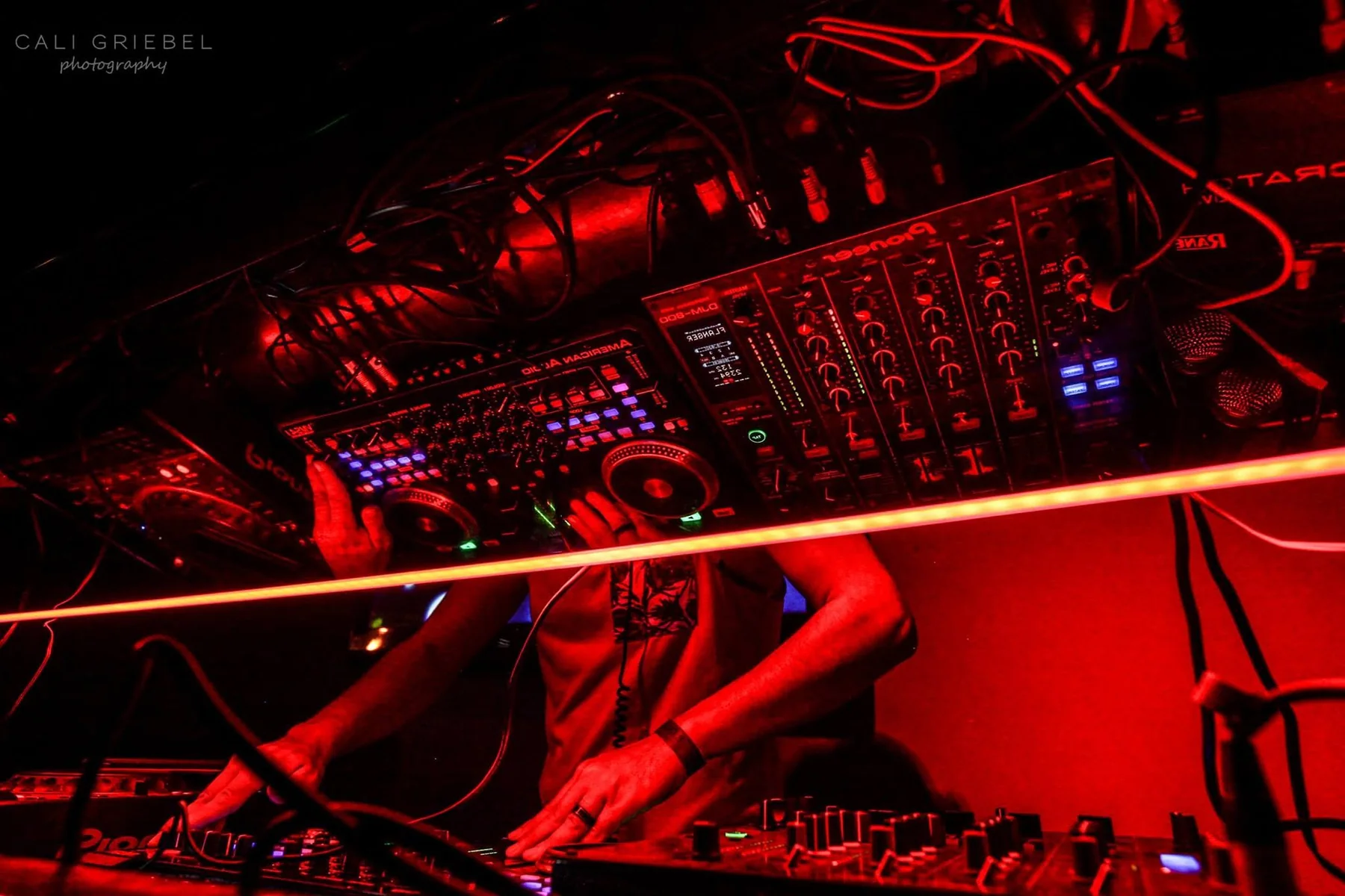 DJ equipment and red nightclub lighting during a DJ Will Z set