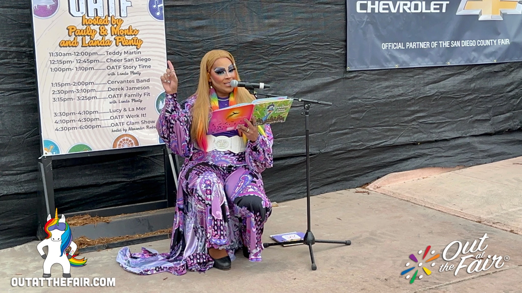 Landa Plenty reading to families during Out at the Fair Drag Story Time