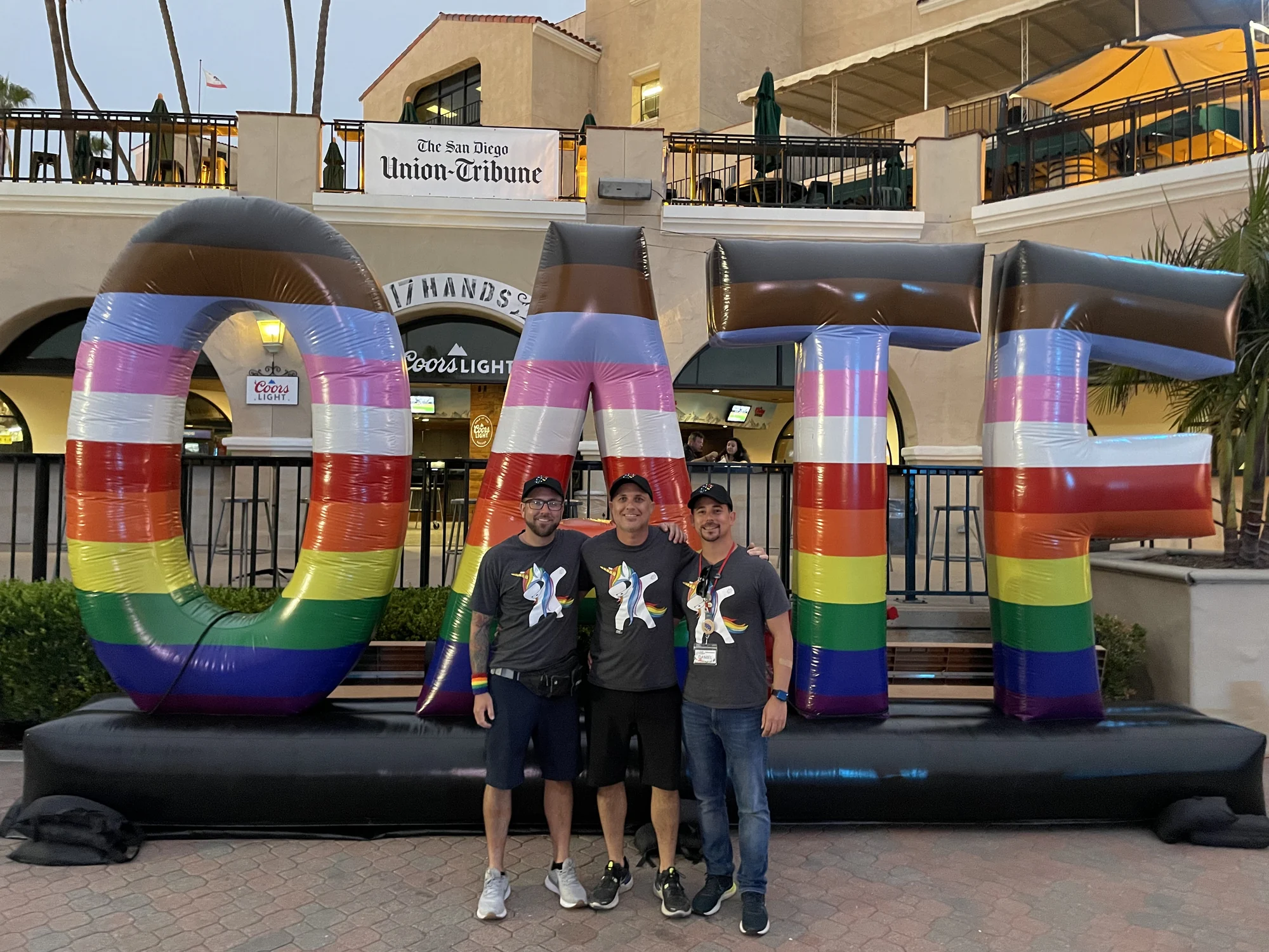 William, Caleb and Daniel standing with a large Out at the Fair sign