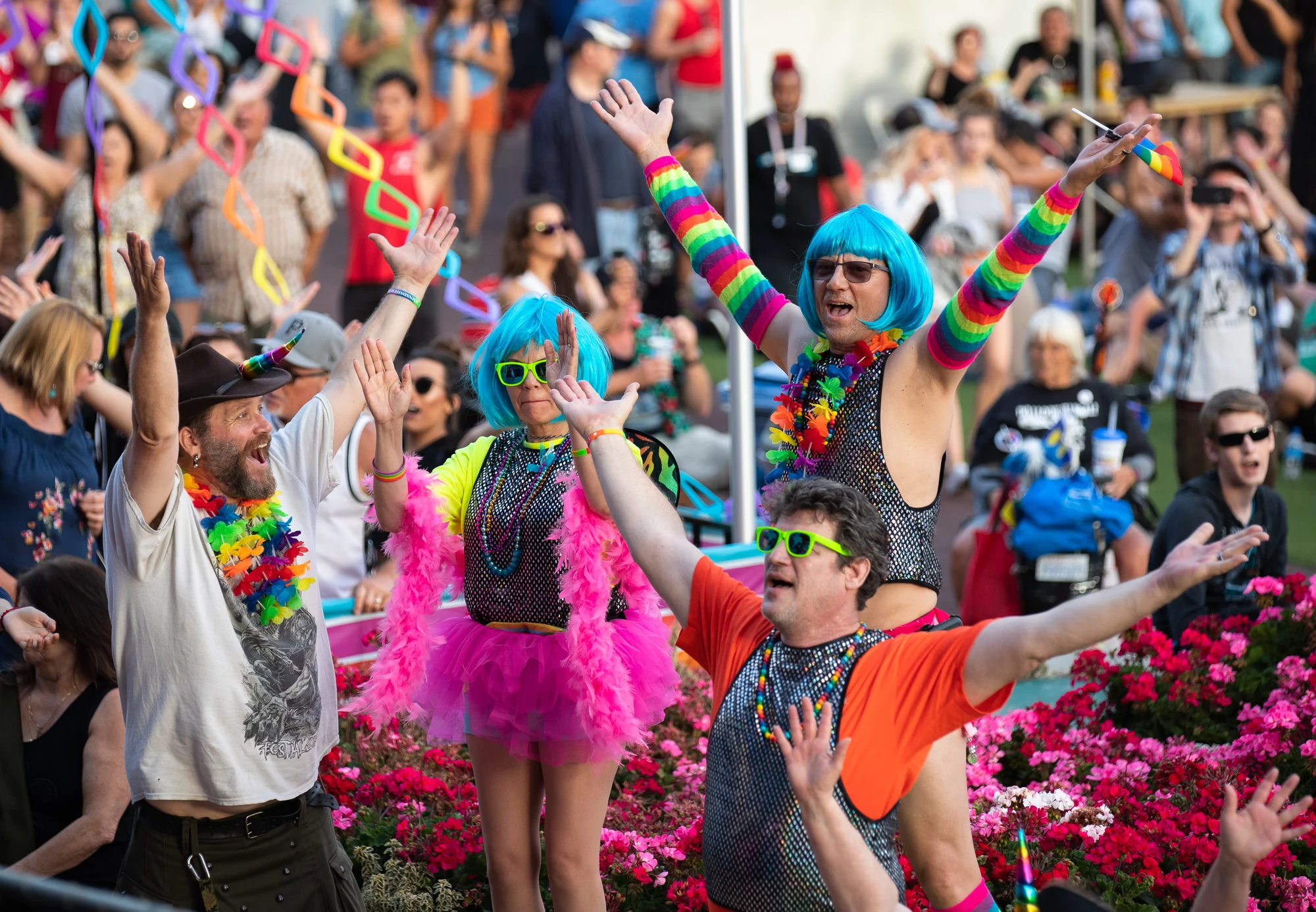 Colorful Out at the Fair performers celebrating in the crowd